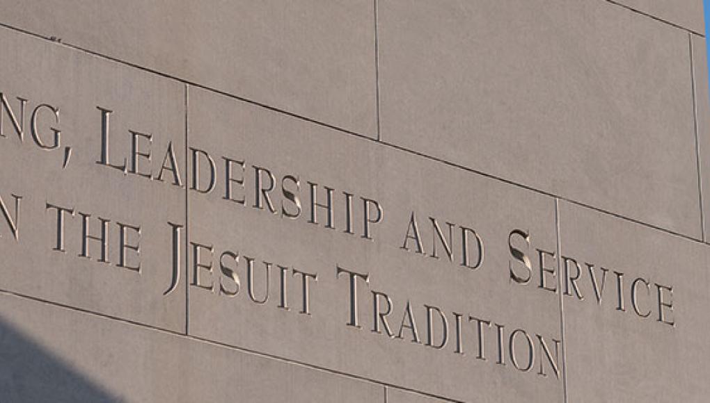 Bell tower inscription. Learning, leadership, and service in the Jesuit tradition