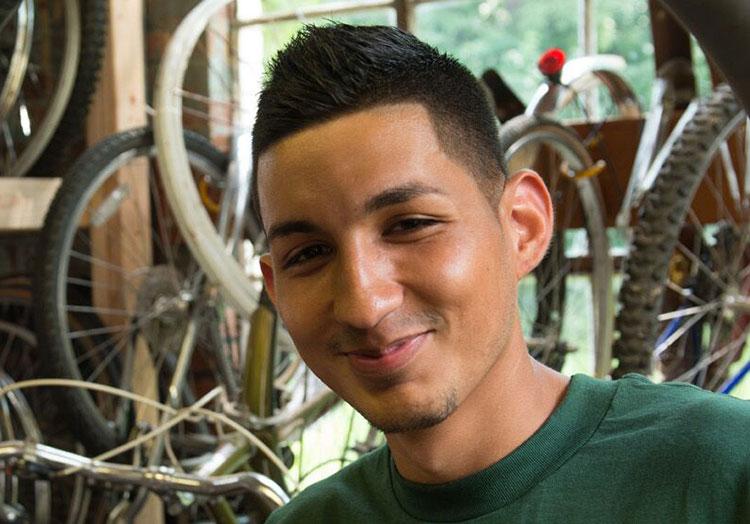 Student serving in local bicycle shop